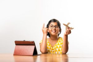 indian-small-girl-student-making-measuring-wings-paper-plane-aeroplane-doing-school-project-learning-science-with-online-tutorial (1) (1)